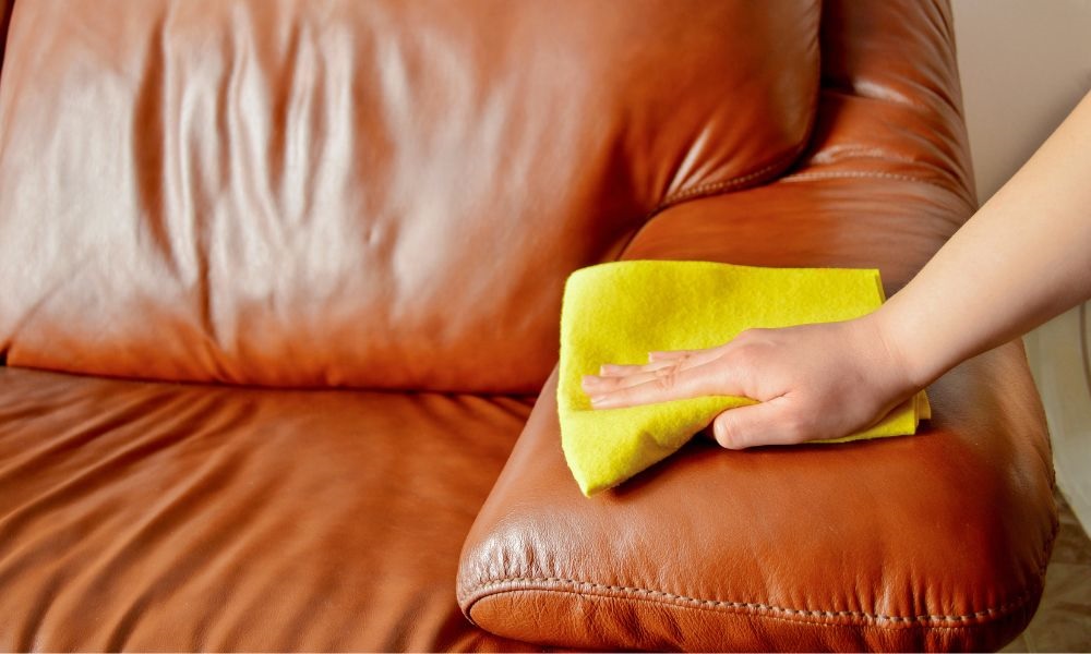 A image of cleaning leather with dry fabric rag