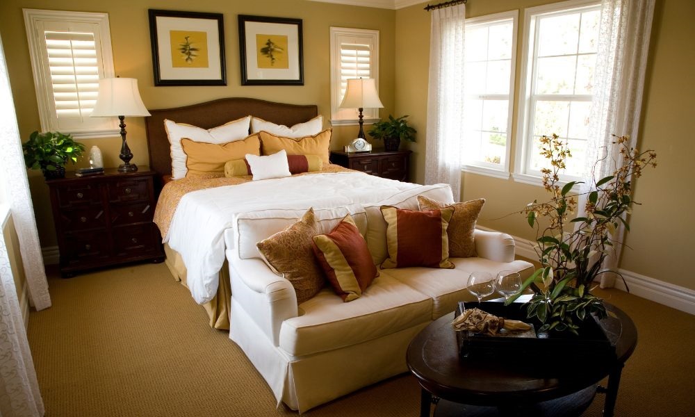 A bedroom with bed   adjacent sofa