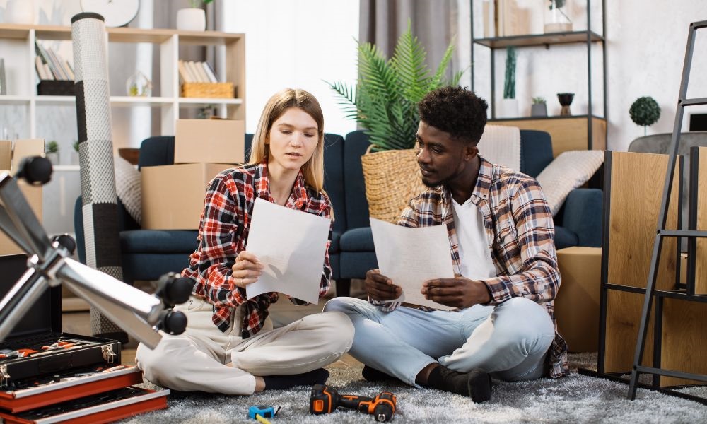 a couple sitting reading a paper in new home