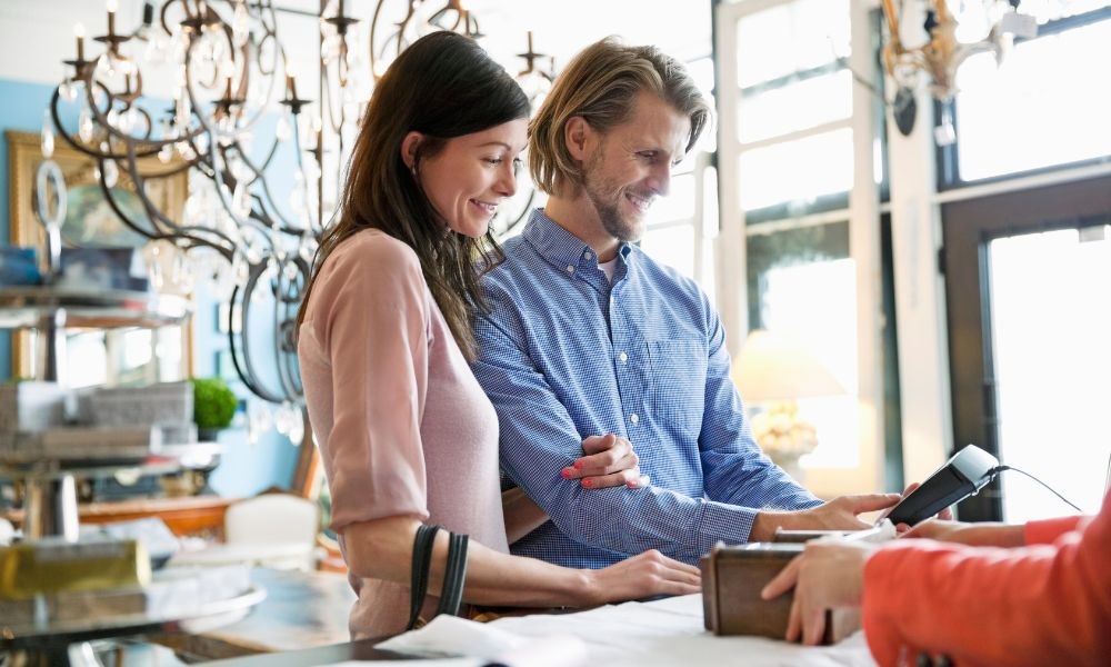 A couple pay with credit card at the counter