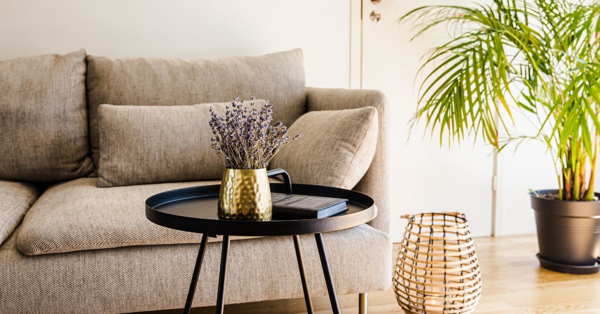 A left portion of Beige Sofa with pillows