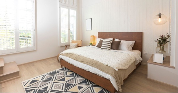 A bright, airy bedroom blends natural light with warm, neutral tones to create a serene and inviting space.